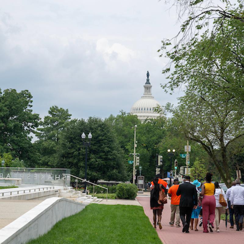 2024 Violence Interrupter Symposium participants walking with Capitol in background