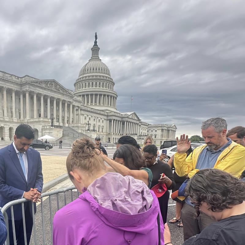 People praying in front of the Capitol