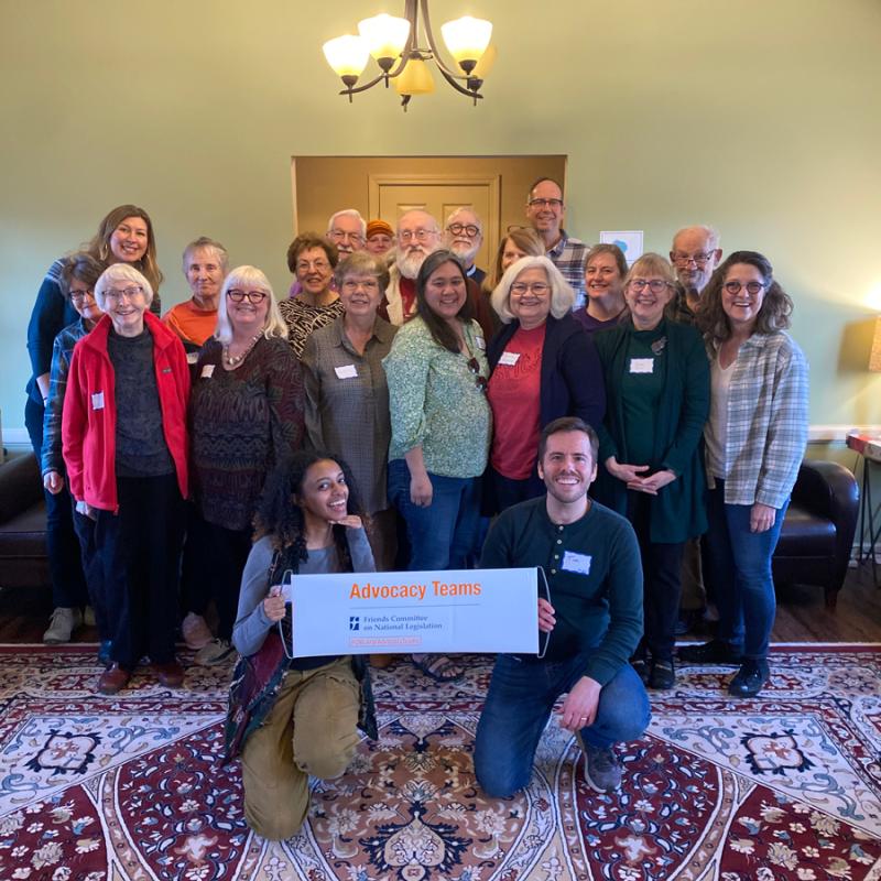Group of advocates smiling behind an Advocacy Teams banner