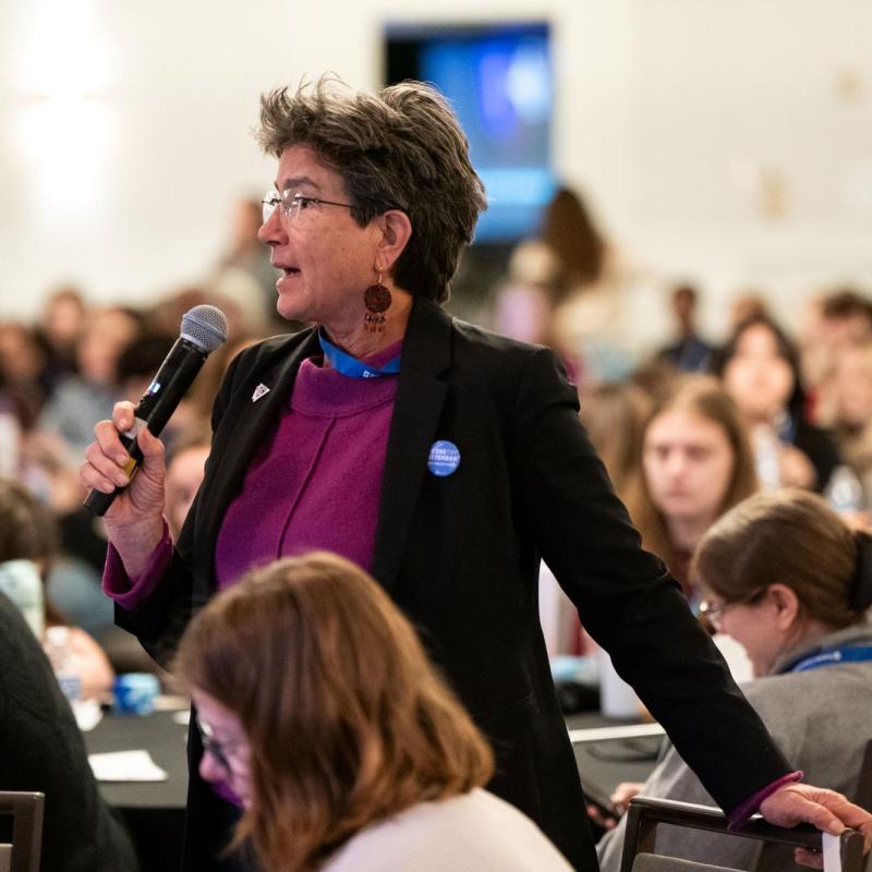 Someone speaking at a microphone
