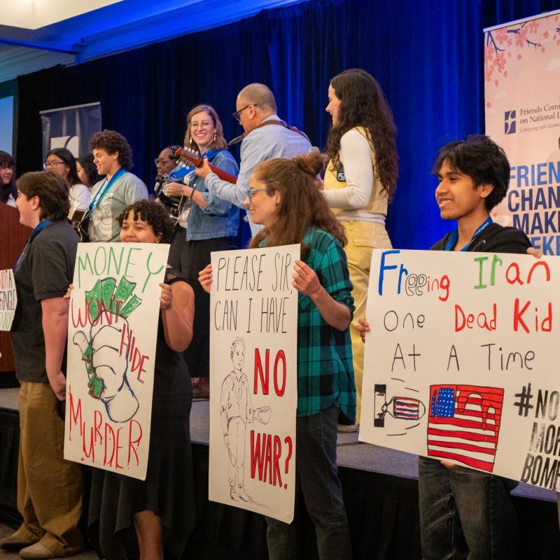 Activists with signs on stage