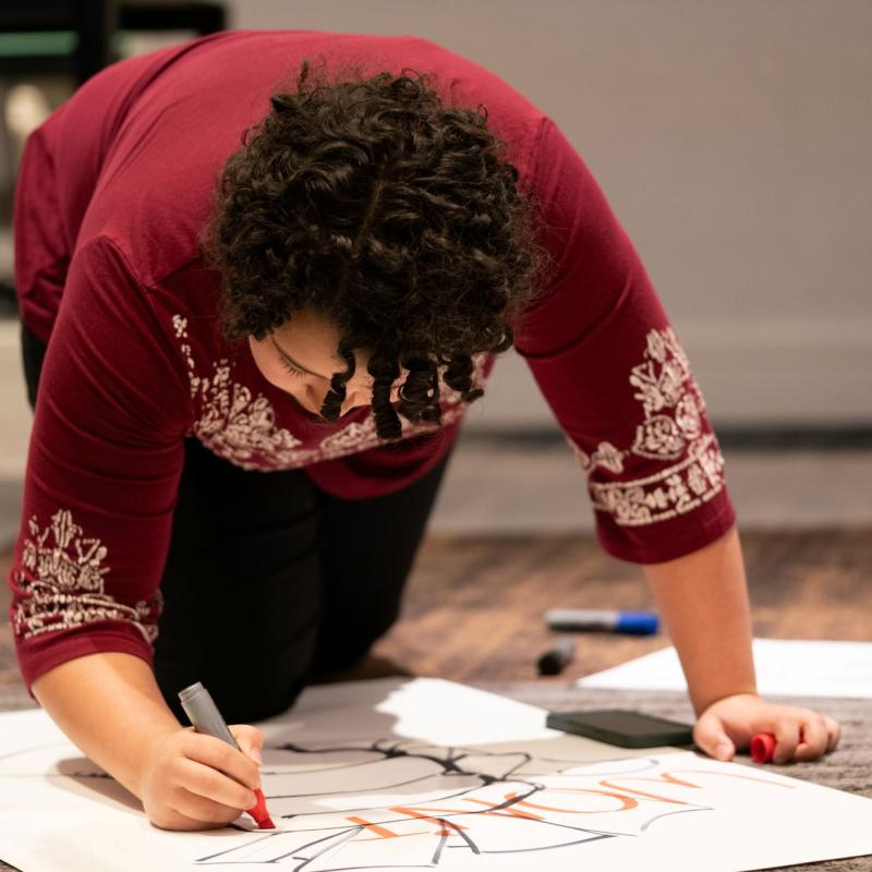 Someone working on drawing a sign