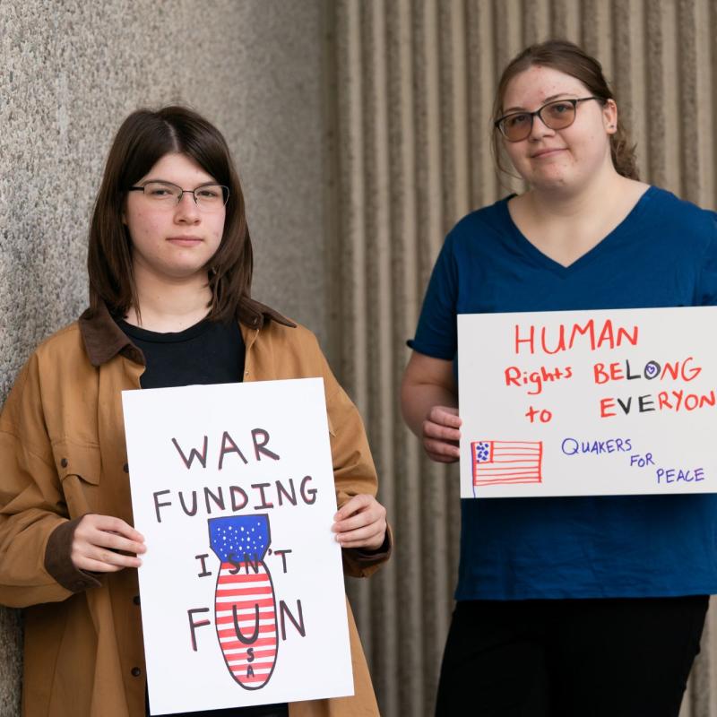 Two people with antiwar signs