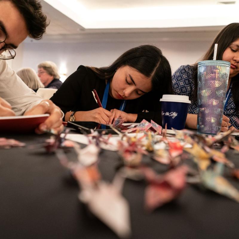 People drawing at a table