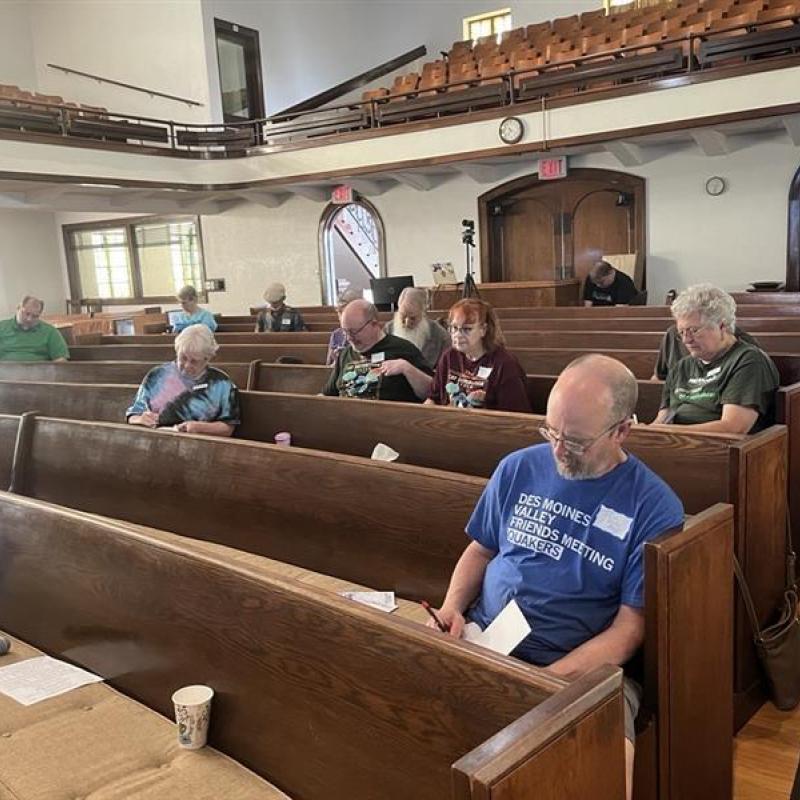 People taking notes in pews