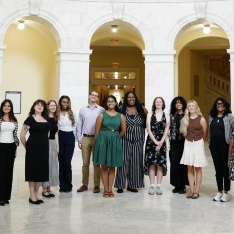Group of young people, professionally dressed in a formal building