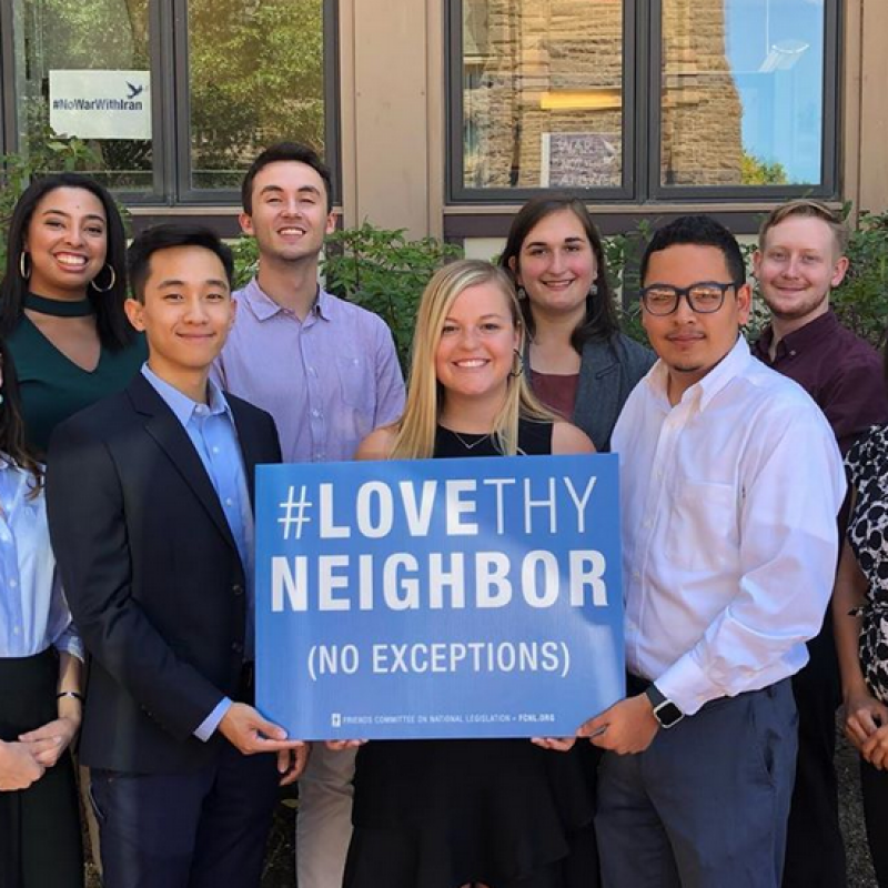 FCNL Young Fellows holding a Love They Neighbor sign