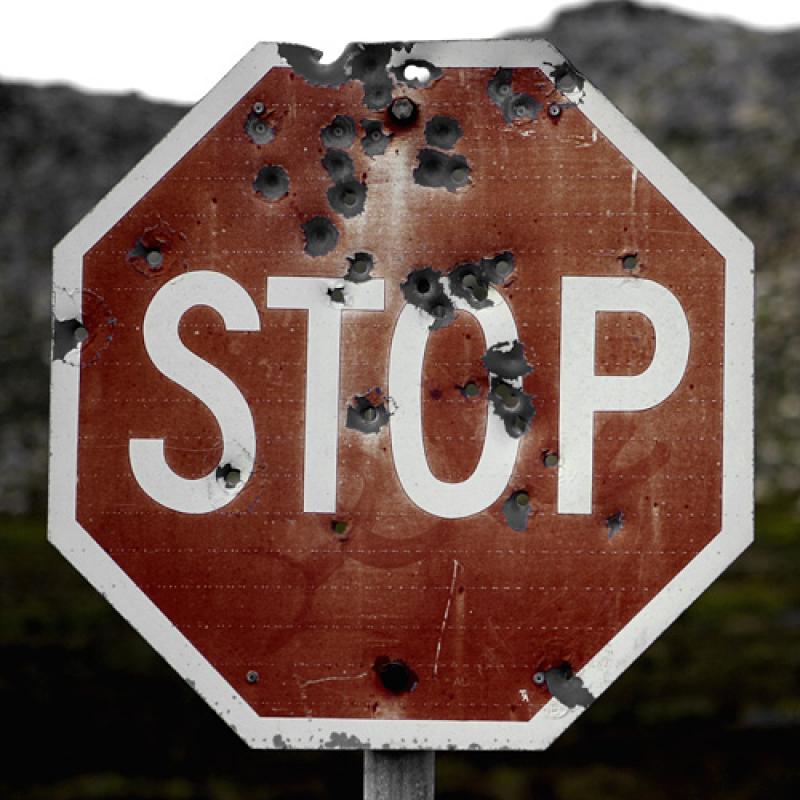 Stop sign with bullet holes