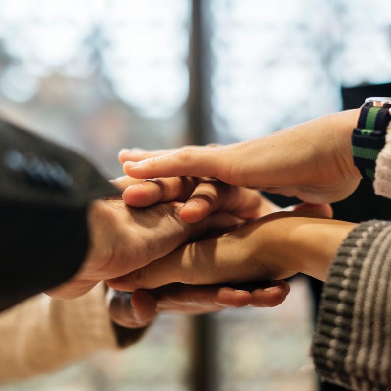 Hands in - let's do this together.