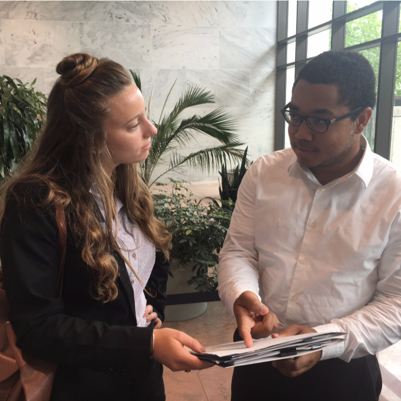 Aurelio and Hannah discuss letters they will be delivering.