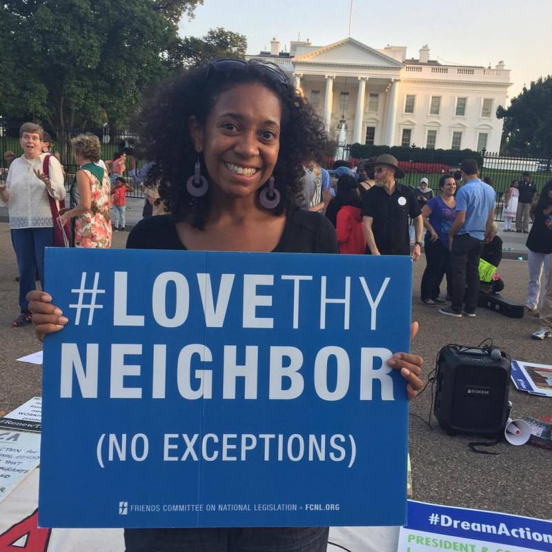 Lauren Brownlee holding Love Thy Neighbor sign at White House
