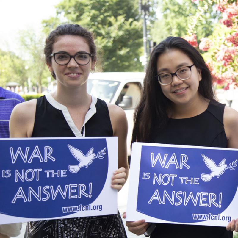 Group of advocates holding "War Is Not The Answer" signs