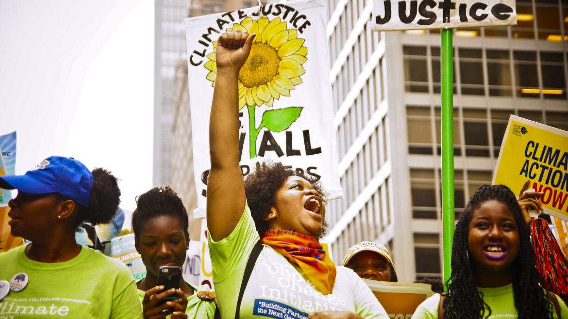 Marchers at the People's Climate march call for  Joe Brusky Climate Justice for All