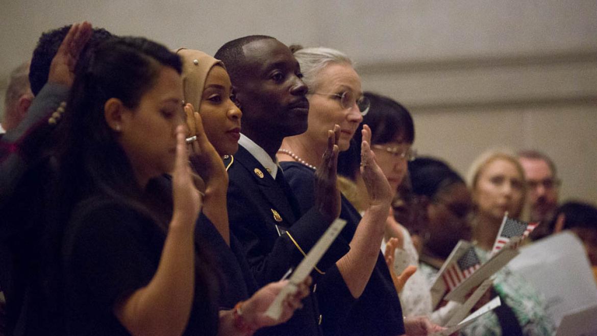 Citizenship candidates take the oath of allegiance during a naturalization ceremony at the National Archives in Washington, DC, on September 17, 2018. 