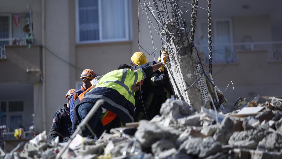 Rescue workers dig through a collapsed building in Turkey following the deadly earthquake that hit Turkey and Syria