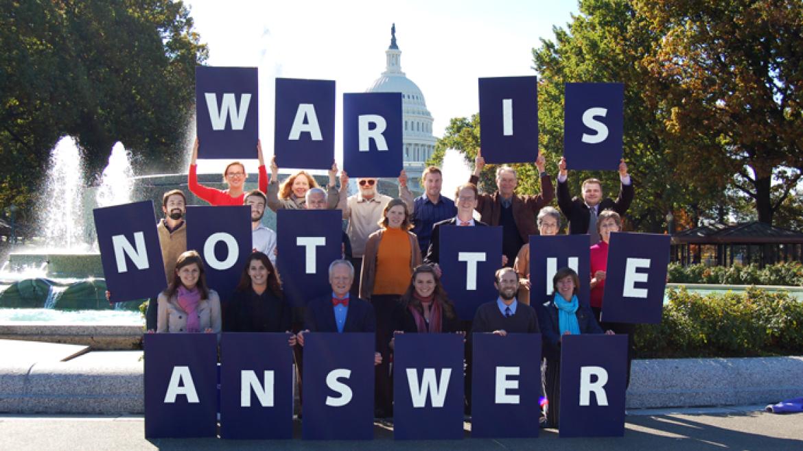 Advocates hold letters that spell out "War is Not the Answer" in front of U.S. Capitol